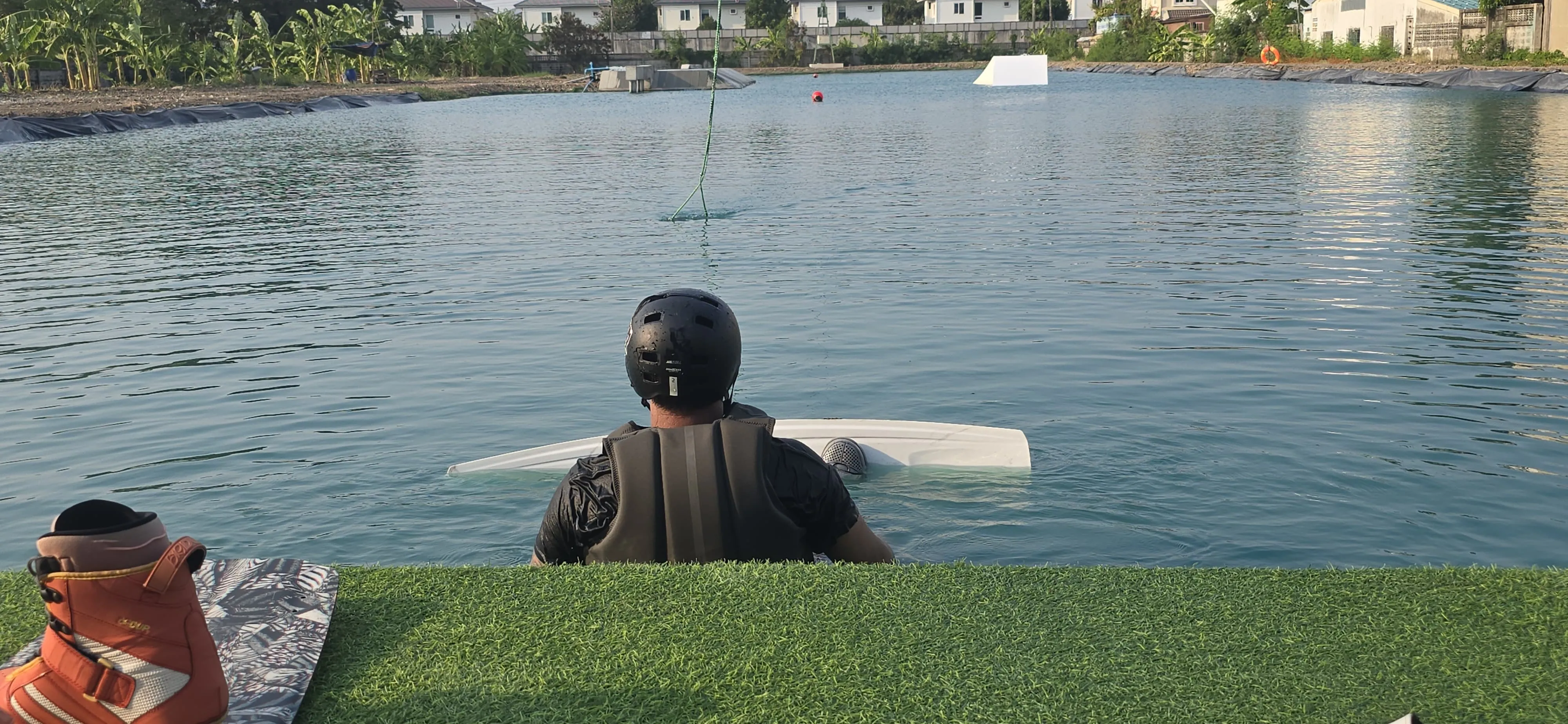 Rider in helmet waiting at the start platform for the 2-tower cable rope, WakeGarden Bang Na beginner wake park