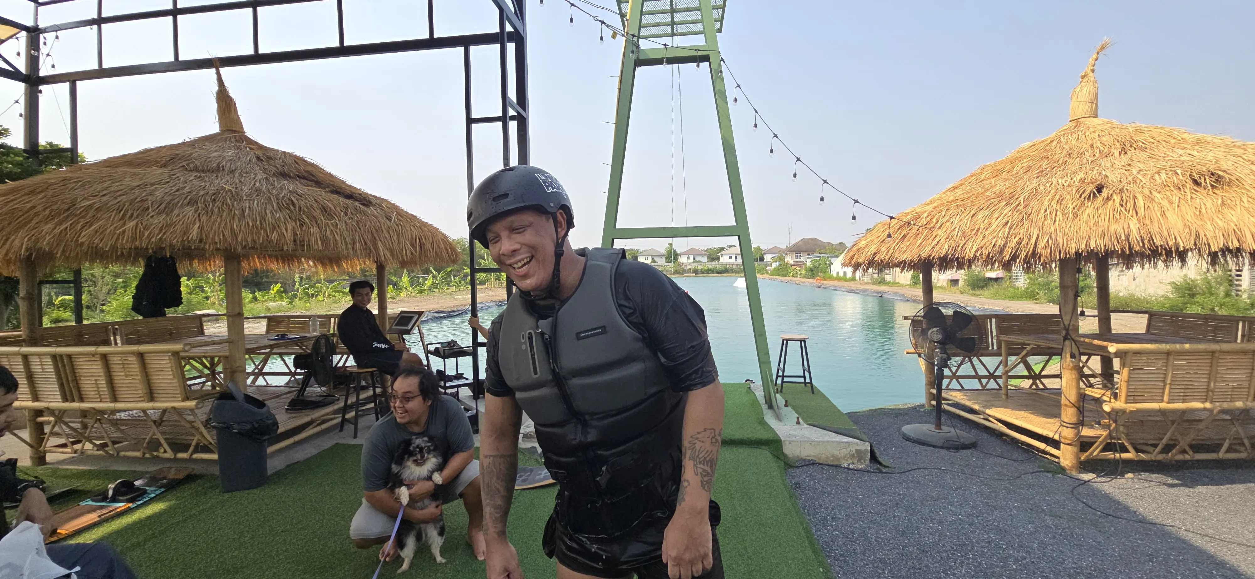 Rider in safety vest smiling in front of the 2-tower cable at WakeGarden Wake Park, Bang Na Bangkok